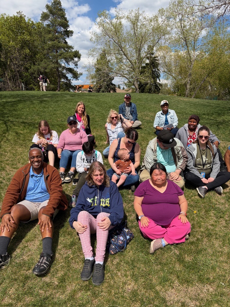 Members of Disability Services Joy Club enjoy the sunshine on the lawn at the Edmonton Valley Zoo.